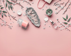 Wall Mural - cosmetic and skin care concept. various facial anti-aging products on pastel pink background with ch