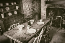 Poor Peasants Interior From 19th Century, Dining Room With Set Wooden Table And Fireplace, Sepia Style Photography