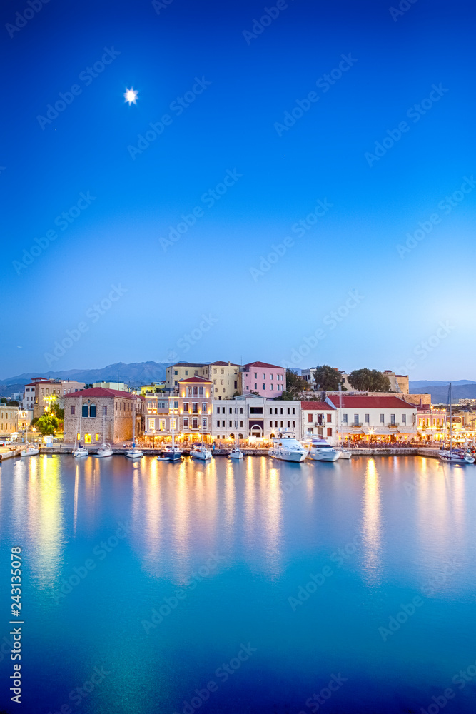 Obraz na płótnie Travel Concepts. Picturesque Image of Old Venetian Harbour of Chania with line of Fisihing Boats and Yachts in the Foregound At Blue Hour in Crete. w salonie