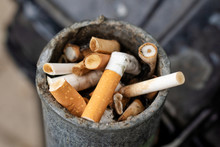 Cigarette Butts In An Outdoors Ashtray