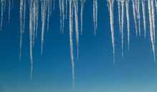 Icicles Hanging In Front Of Blue Sky