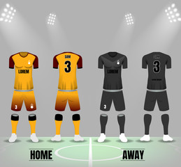 Soccer uniforms in yellow and black on soccer field and spotlight