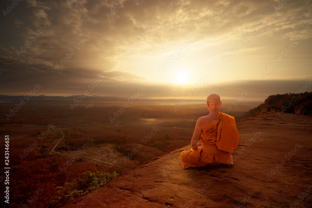Buddhist monk in meditation at beautiful sunset or sunrise background on high mountain - obrazy, fototapety, plakaty 