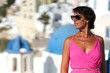 © jekatarinka - Woman with Fuchsia dress admires the Oia Scenery in Santorini