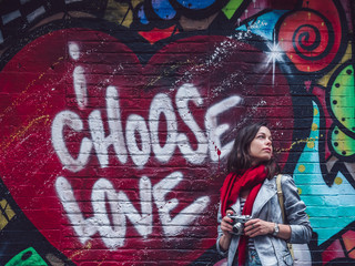 Young photographer by the wall with graffiti