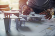 © Chaosamran_Studio - architect design working drawing sketch plans blueprints and making architectural construction model in architect studio