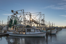 Shrimping Boats At Rest On Empty Docks As Sun Sets