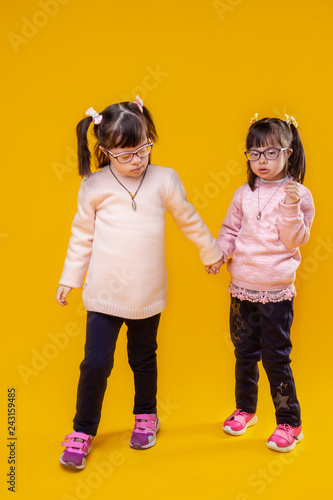Valokuva Dark-haired pretty girls with down syndrome and unusual face features