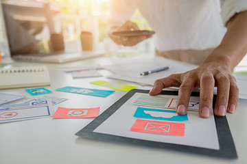 Wall Mural - Creative Web Designer planning application and developing template layout, framework for mobile phone. User experience (UX) concept.