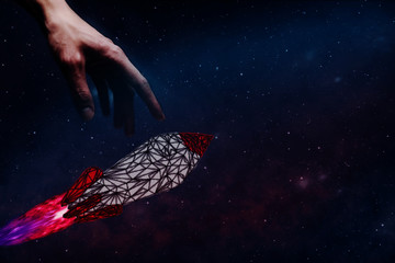 Leinwandbilder - Human hand holding Rocket. Nebula dust. Mixed media.
