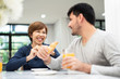 © eggeeggjiew - Happy Young couple enjoying breakfast.