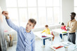 © pressmaster - Serious schoolboy writing something on blackboard at lesson in front of teacher and classmates