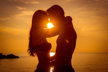 Young Couple Is Kissing At The Sea