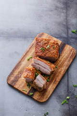 Thai crispy skin pork belly on wooden board, copy space