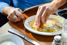 Dipping Fresh Baked Bread Into Olive Oil