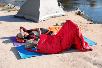 Sticker - Campers lying in sleeping bags on wild beach