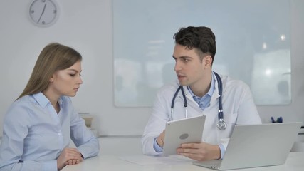 Patient Having Consultation with Doctor, Using Tablet in Clinic
