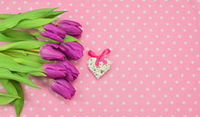 Valentine's A Composition Of Purple Tulips, A Rattan Heart With A Pink Ribbon, On A Pink Material With White Polka Dots