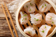 Chinese prawn dumplings dim sum placed in a bamboo steamer. horizontal top view