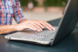 © undrey - Close up shot of female hands typing on a laptop keyboard