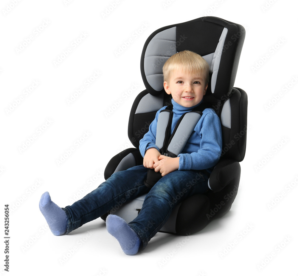 Baby boy buckled in car seat on white background