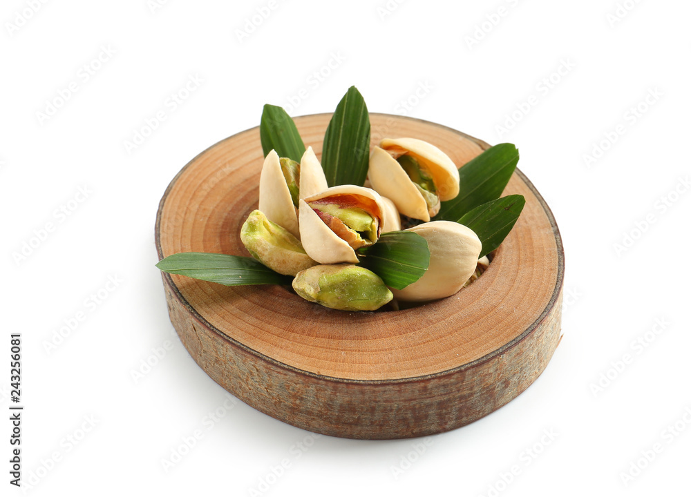 Wooden stand with tasty pistachio nuts on white background