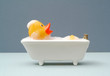 © martin - rubber duck taking a bath. grey baackground