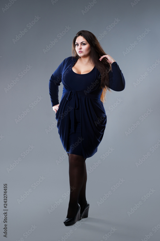 Plus size fashion model in blue dress, fat woman on gray studio background,  overweight female body Stock Photo | Adobe Stock