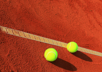 Tennis balls on a tennis clay court