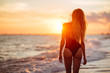 © Margo Basarab - carefree woman dancing in the sunset on the beach. vacation vitality healthy living concept