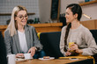 © LIGHTFIELD STUDIOS - attractive friends chatting in cafe with drinks