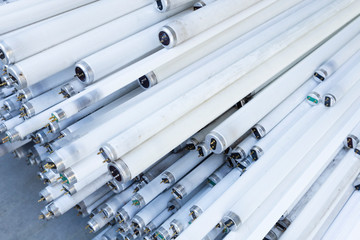 Close-up of a stack of disused and discarded neon lamp tubes waiting for recycling