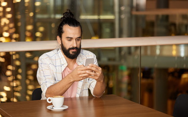 Sticker - people, technology and leisure concept - man drinking coffee and messaging on smartphone at restaurant or cafe