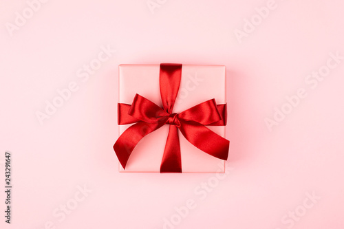 Pink gift box with red bow on the pink background. Valentine's day, 8 of Marc...