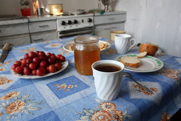 Wall Mural - tea with honey and plum covered table