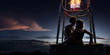 Young beautiful multiethnic couple kissing in the hot air balloon. Very romantic picrure night and sunrise around