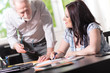 © thodonal - Young businesswoman and senior businessman working together