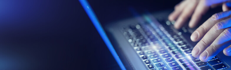 Close-up of male hands and laptop