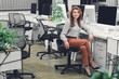 © LIGHTFIELD STUDIOS - attractive young businesswoman sitting at workplace and smiling at camera
