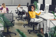 © LIGHTFIELD STUDIOS - african american businesswoman holding cup and talking by smartphone while working with colleagues in office