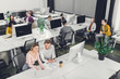 © LIGHTFIELD STUDIOS - high angle view of young business colleagues sitting and working together in open space office
