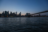 Fototapeta  - View from the sea on the evening of New York and the bridge