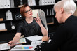 © Ivan Traimak - Business women discuss diagrams at Desk in office