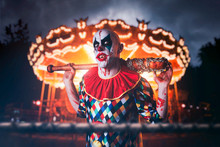 Crazy Clown With Baseball Bat In Amusement Park