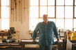 © Jacob Lund - Senior man standing by a table in his carpentry workshop