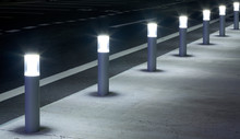 A Row Of Column Lighting In Parking Place At Night