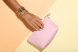 © 5second - Female hand with bracelets and handbag on colorful background