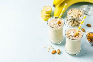 Banana ginger cinnamon almond smoothie with coconut flakes. Selective focus, space for text.