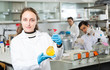 © JackF - Female chemist analyzing liquid in test flasks