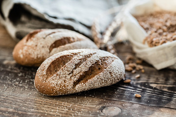 Wall Mural - fresh bread with flour on the wooden background